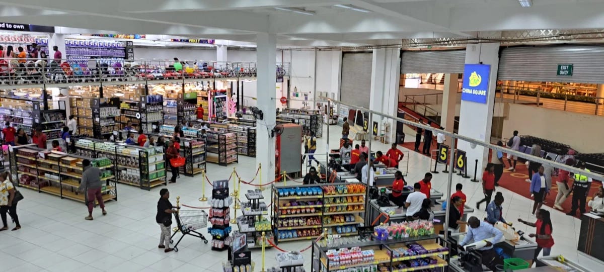 A pictue of the main doors of China Square from the inside where we can see shoppers paying for their products