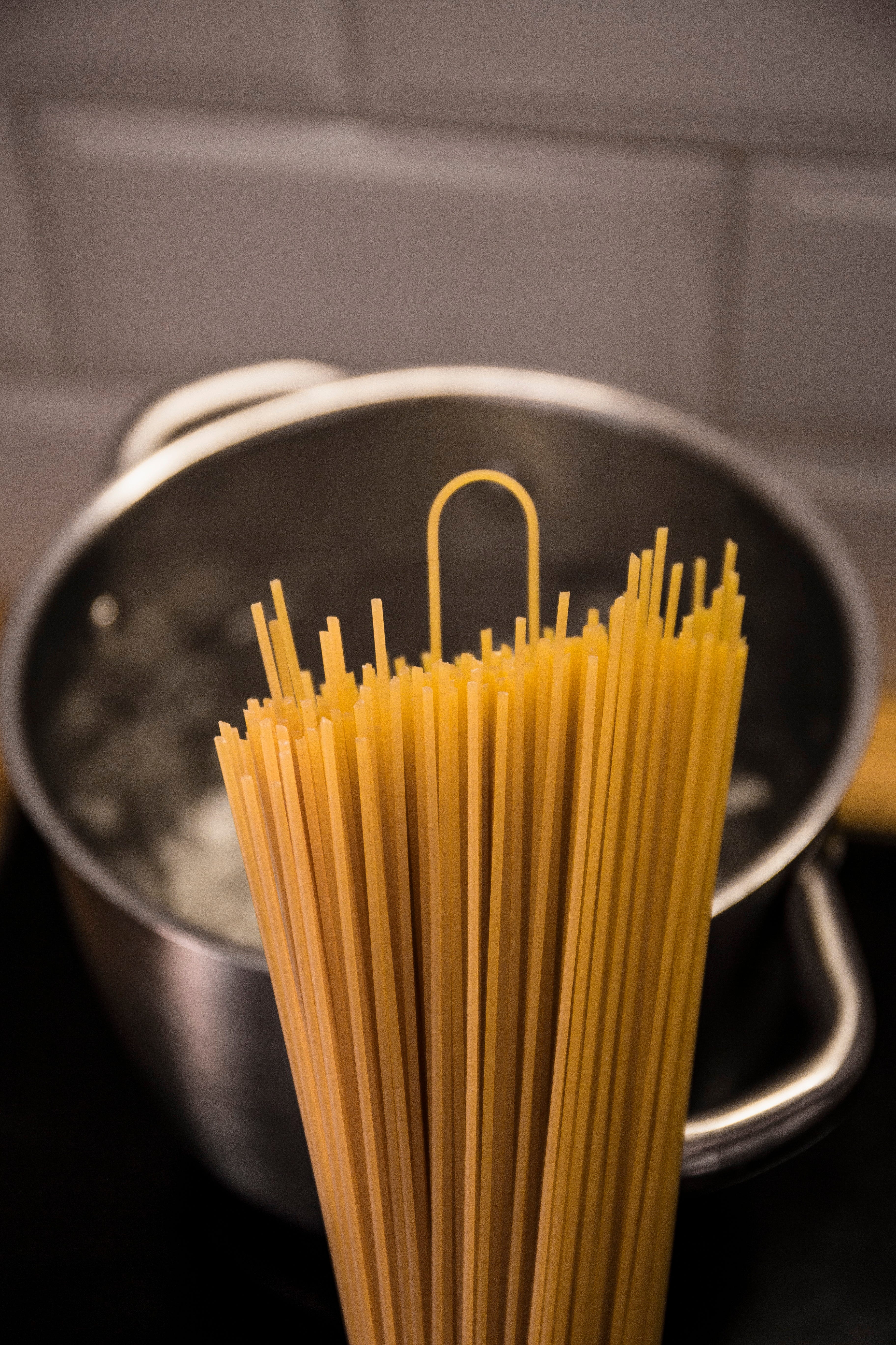 yellow pasta on stainless steel bowl pre-cooking | Optimal Cooking Time for Perfectly Separated Pasta Strands