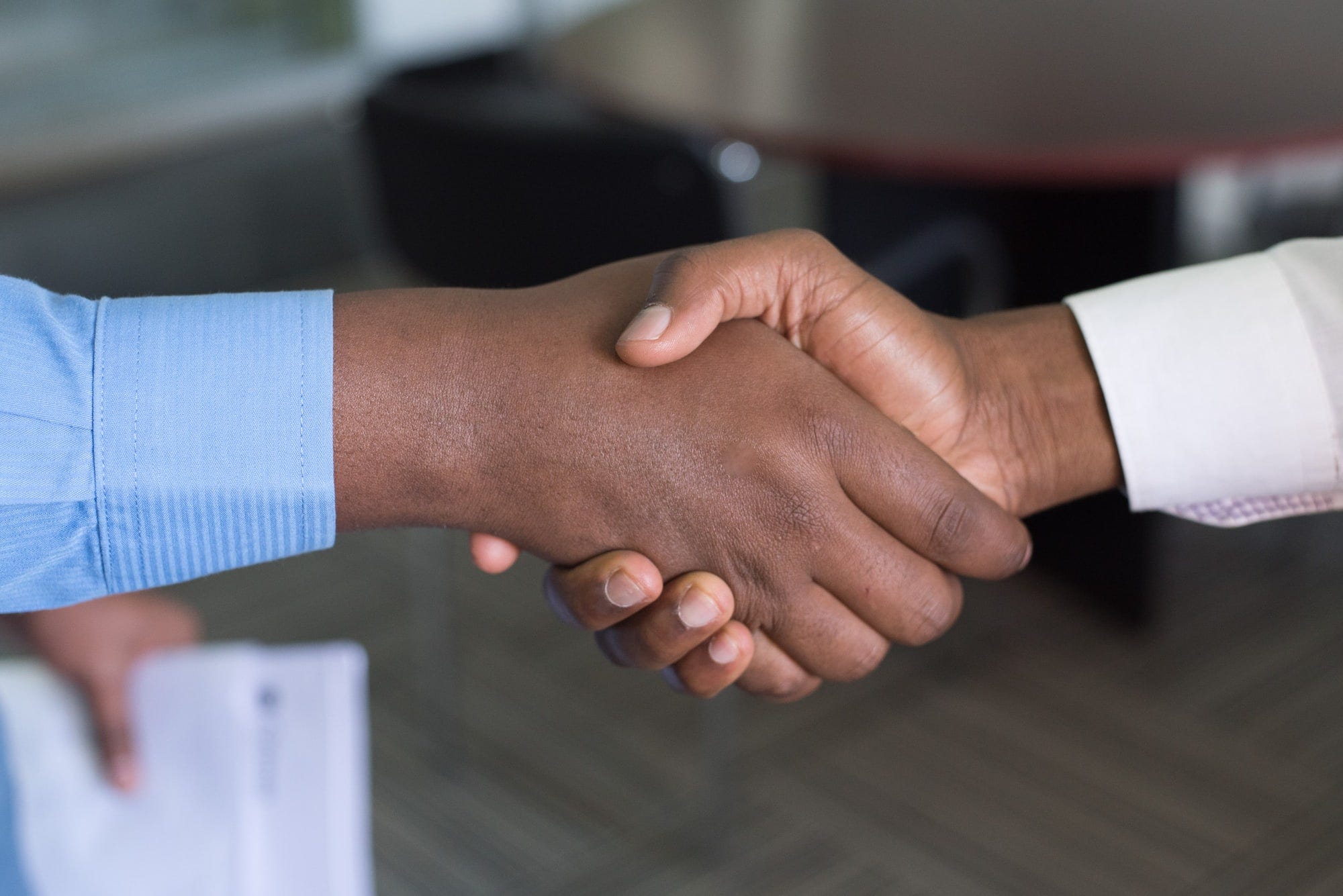 A photo of two people shaking hands