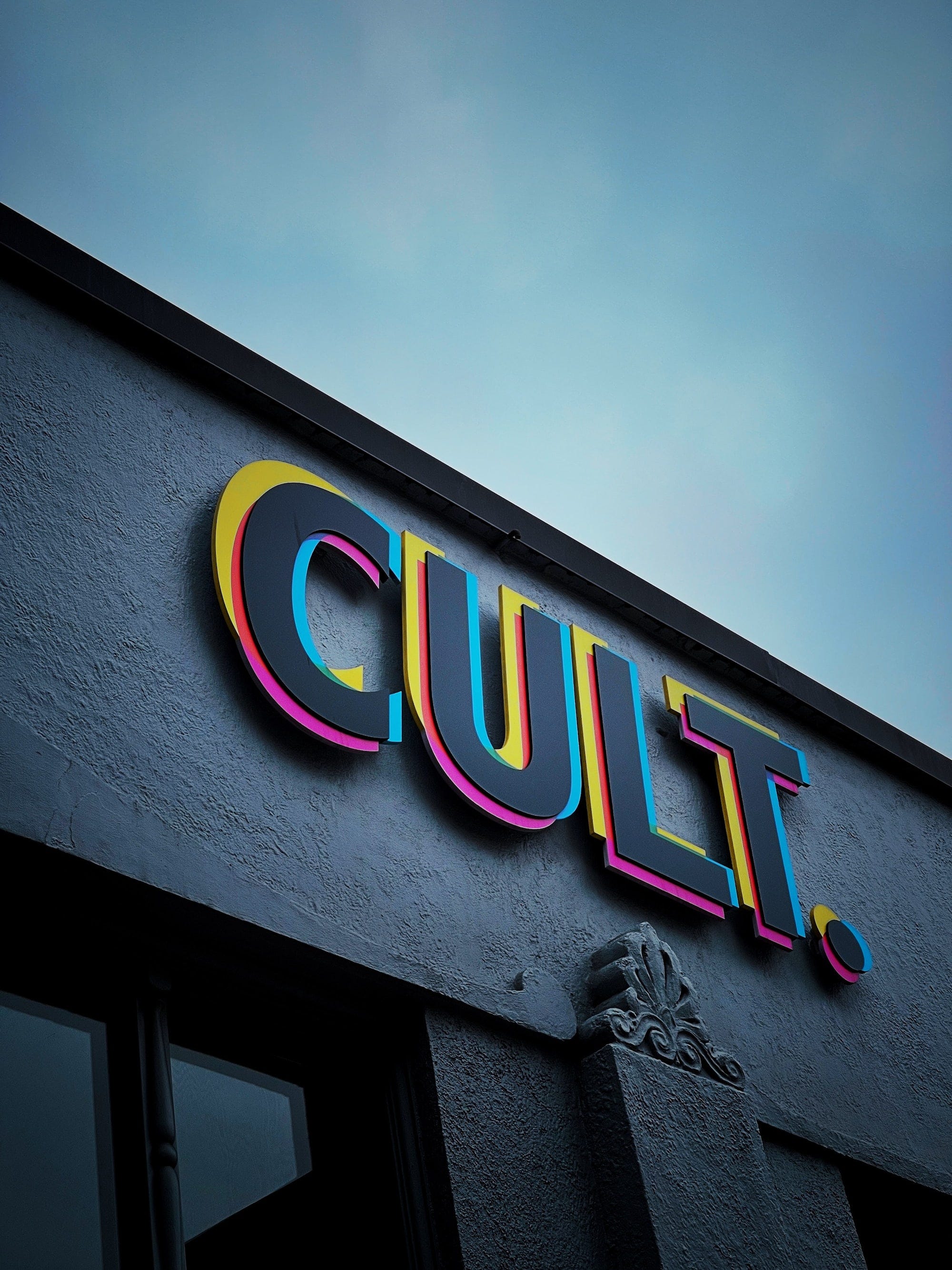 A sign reading 'Cult' on the side of a building