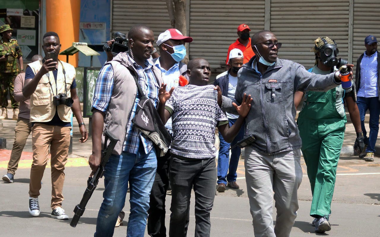 Plain-clothed police arresting a protestor in Nairobi Central Business District during the Azimio protests