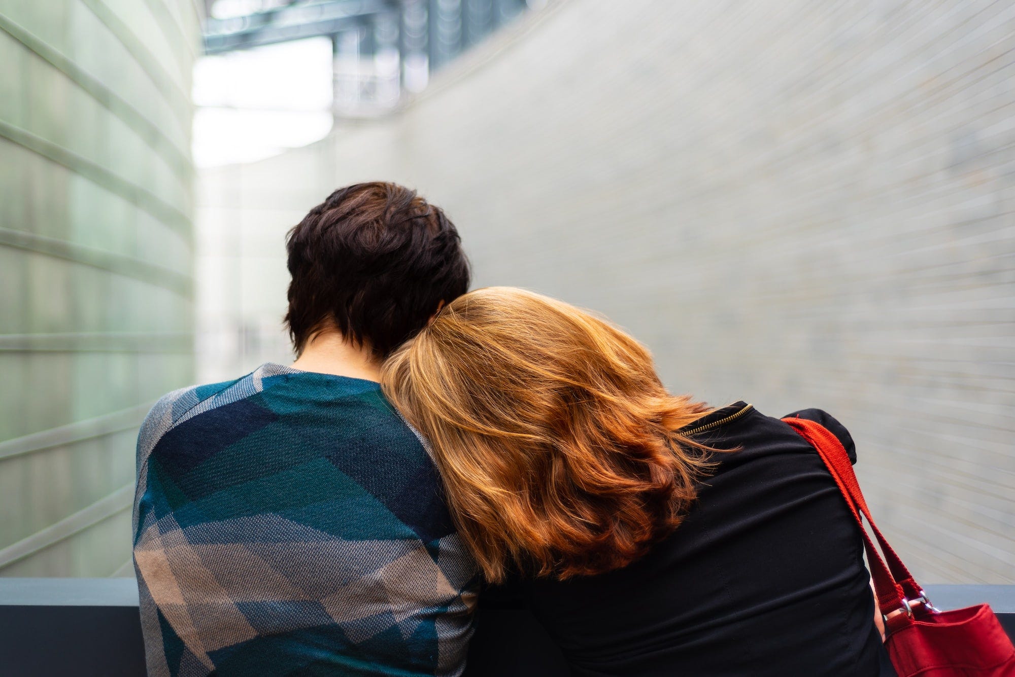 A picture of a woman lying her head on a man's shoulders