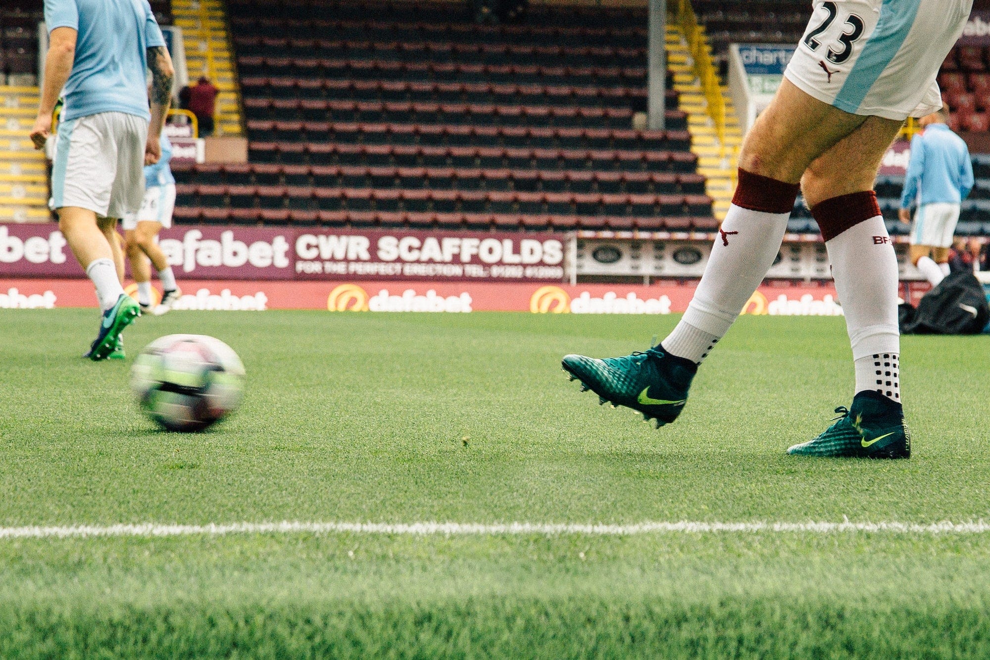 A Premier League footballer passing the ball