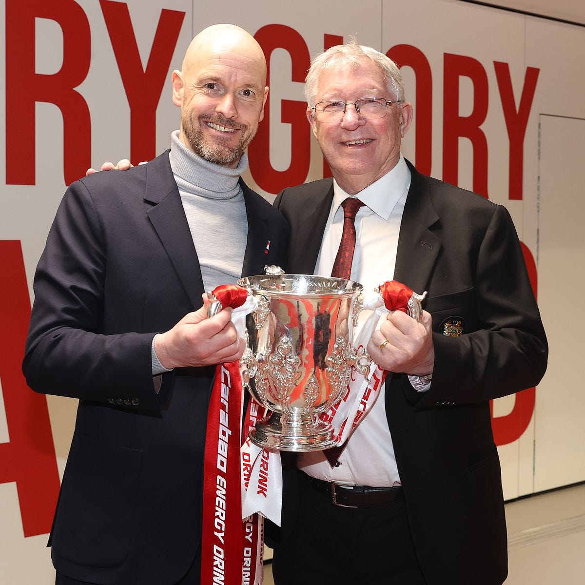 Sir Alex Ferguson with Man Utd manager Erik ten Hag, both holding the Carabao Cup Trophy