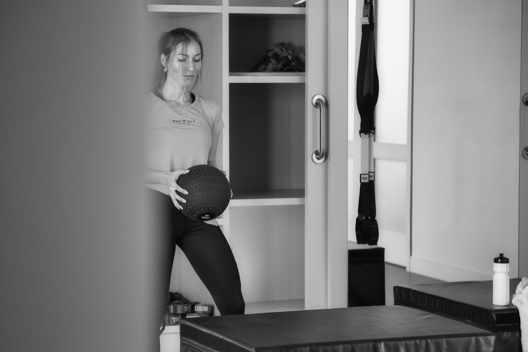 A woman holding a med ball during strength training