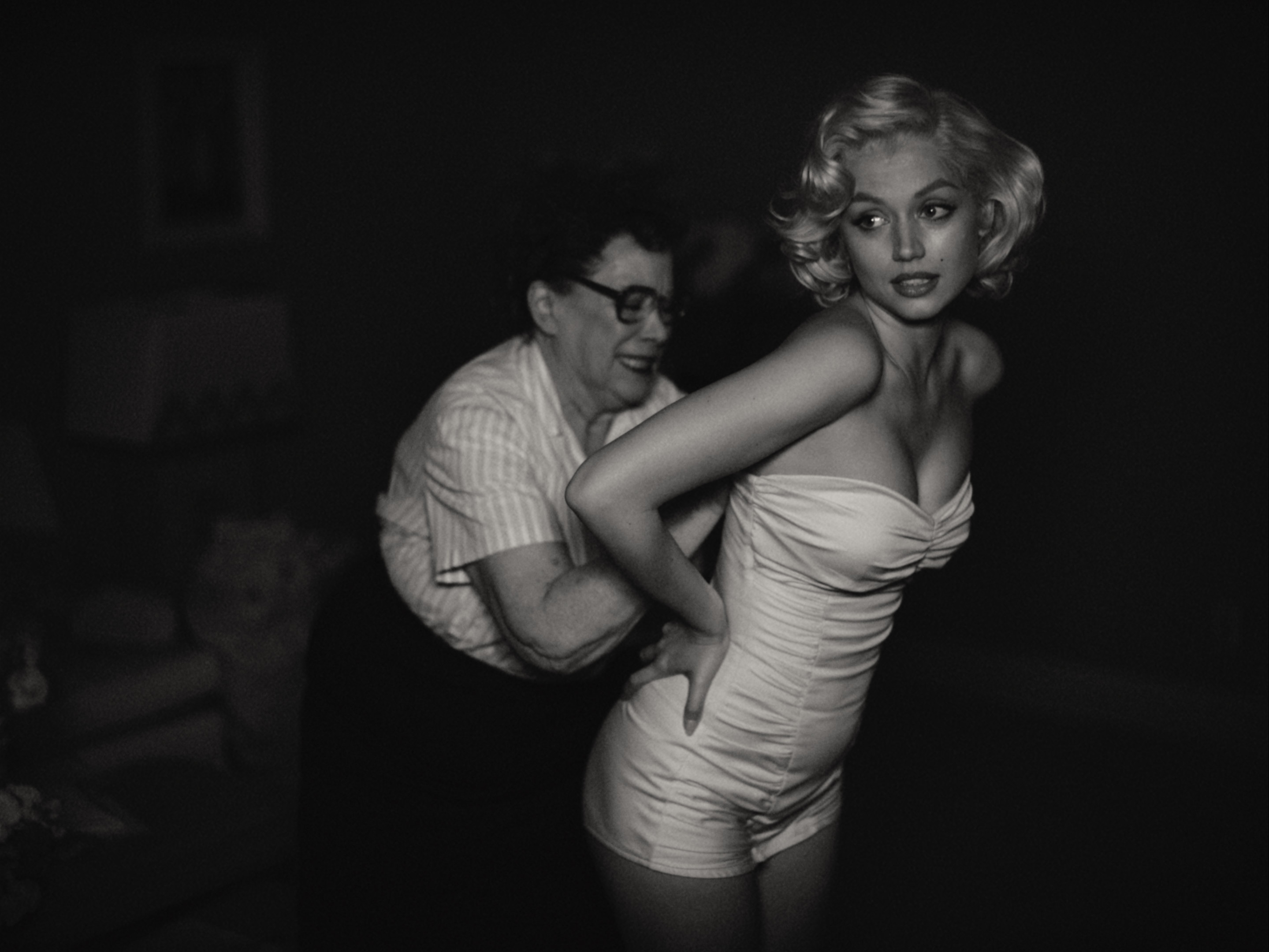 Marilyn being squeezed into a corset in Blonde