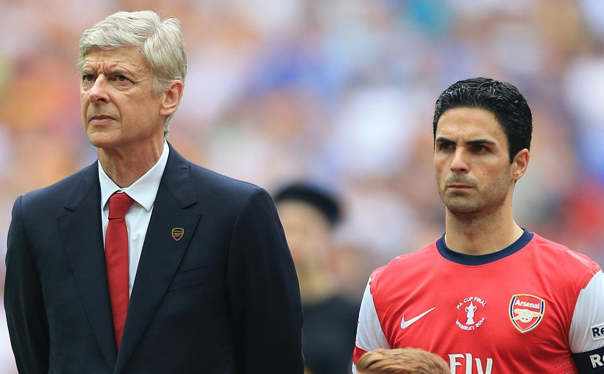 Arsene Wenger standing next to Mikel Arteta back when Wenger was coach and Arteta a player for Arsenal