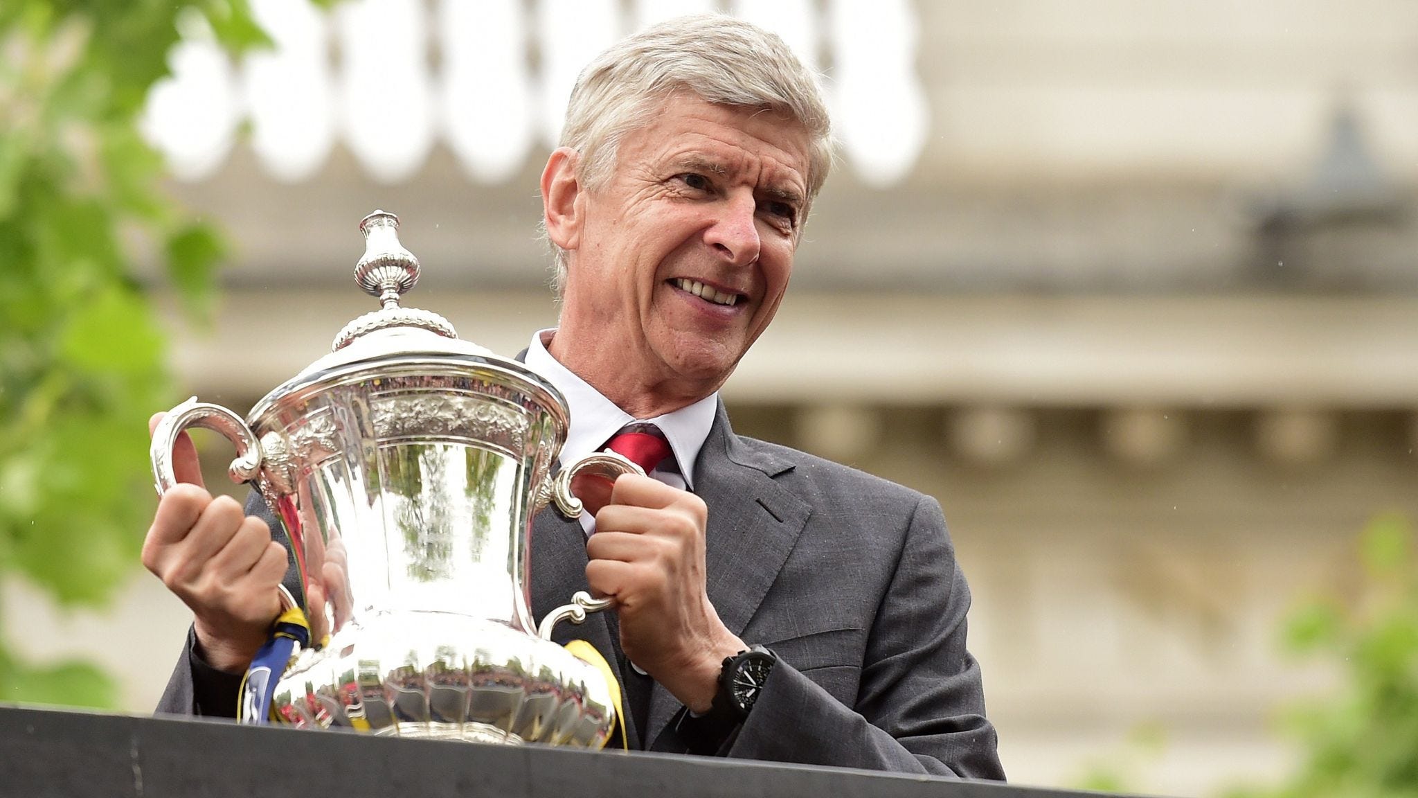 Arsene Wenger holding the FA Cup Trophy