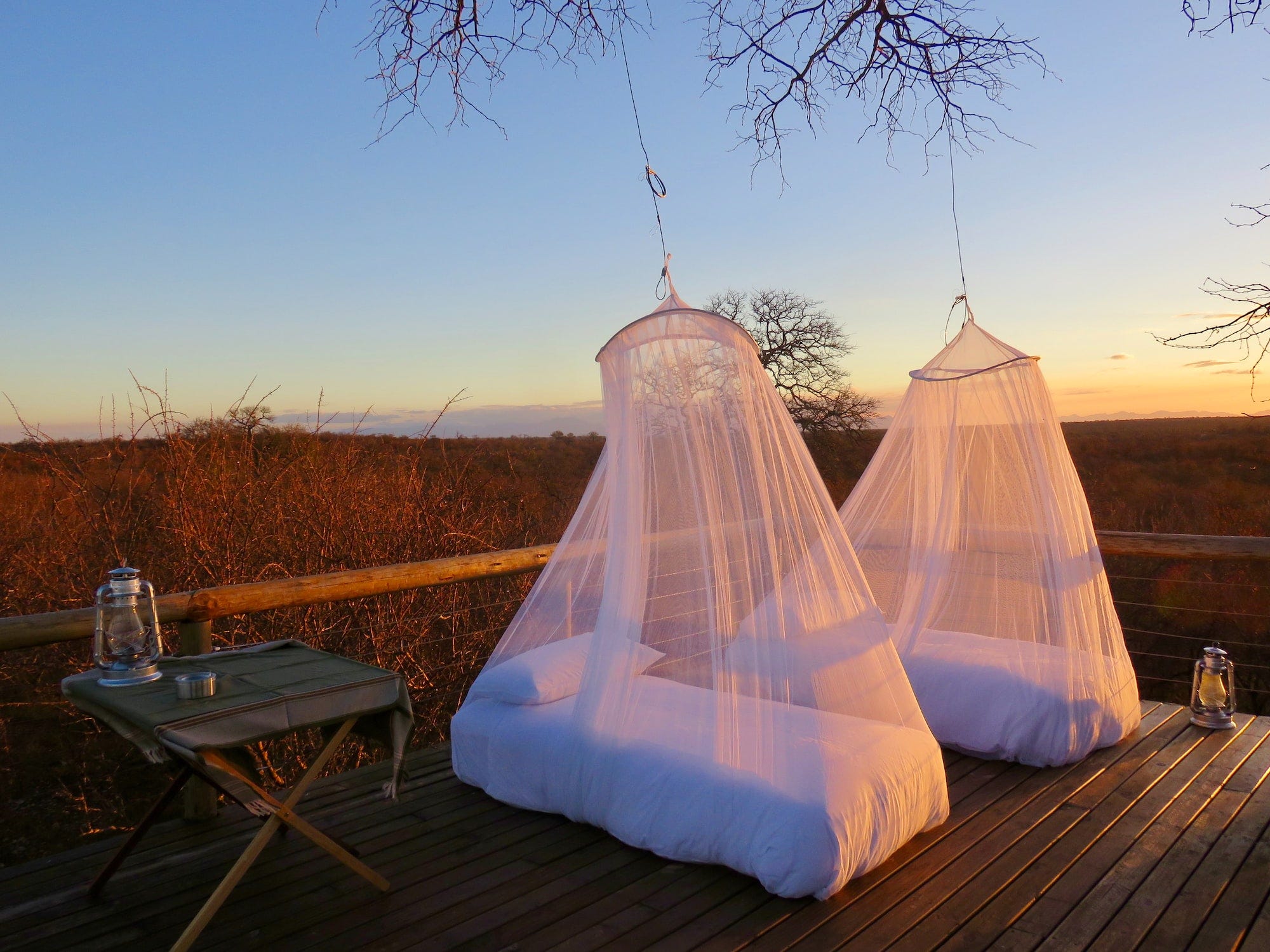 Mosquito nets on patio beds in a game reserve. There is a need to raise awareness about mosquito bite prevention methods such as the use of treated mosquito nets