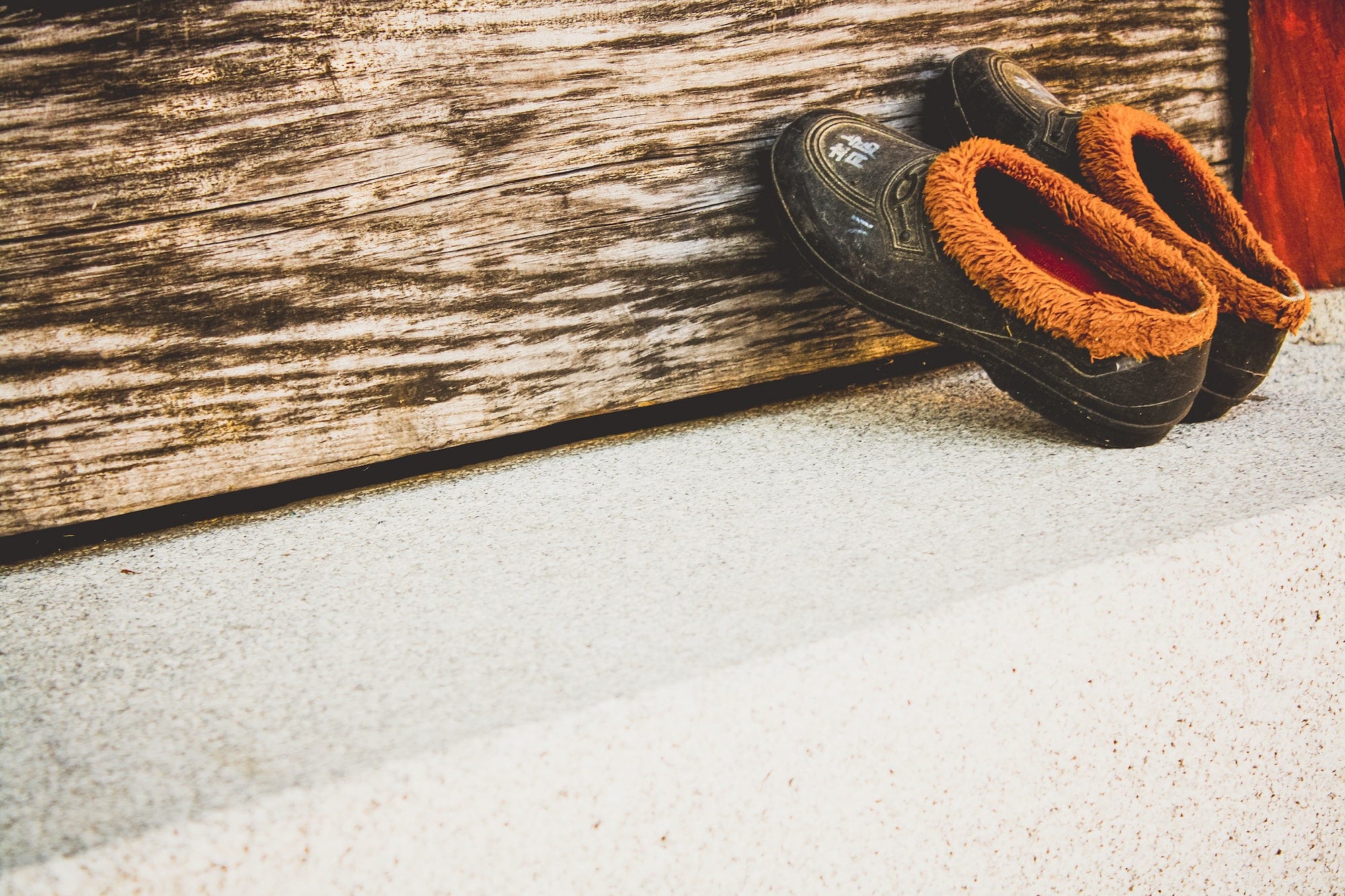 A pair of slip-on laceless shoes with chinese writing