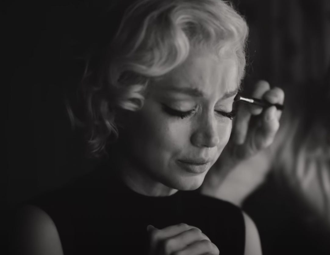 A tearful Norma Jean in Blonde while she's being applied makeup