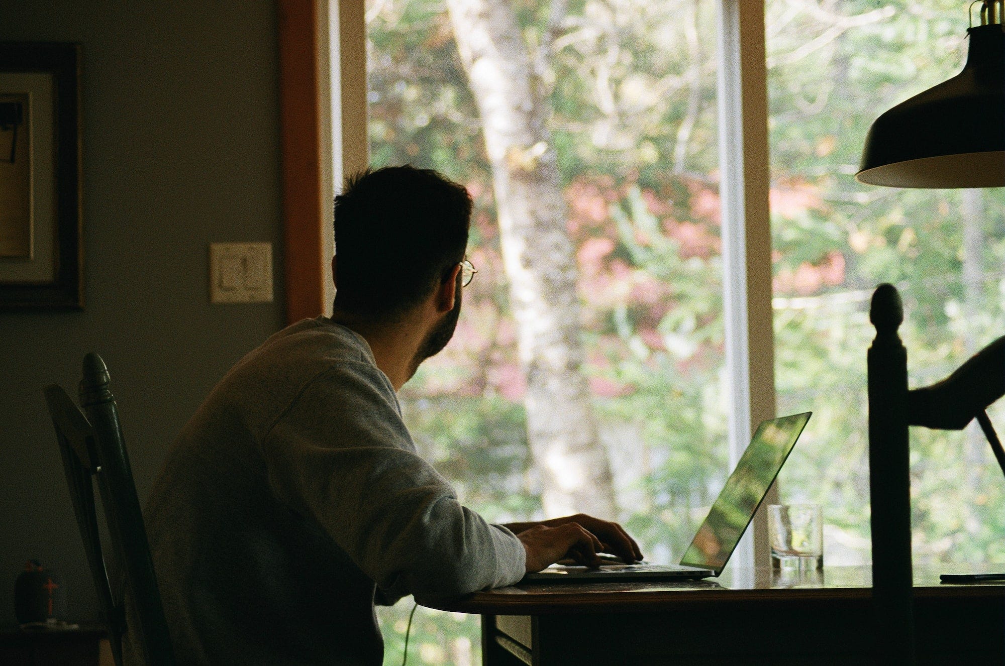 A man working from home looking outside