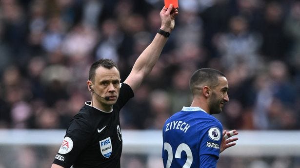 Referee Stuart Attwell issuing a red card to Chelsea's Hakim Ziyech