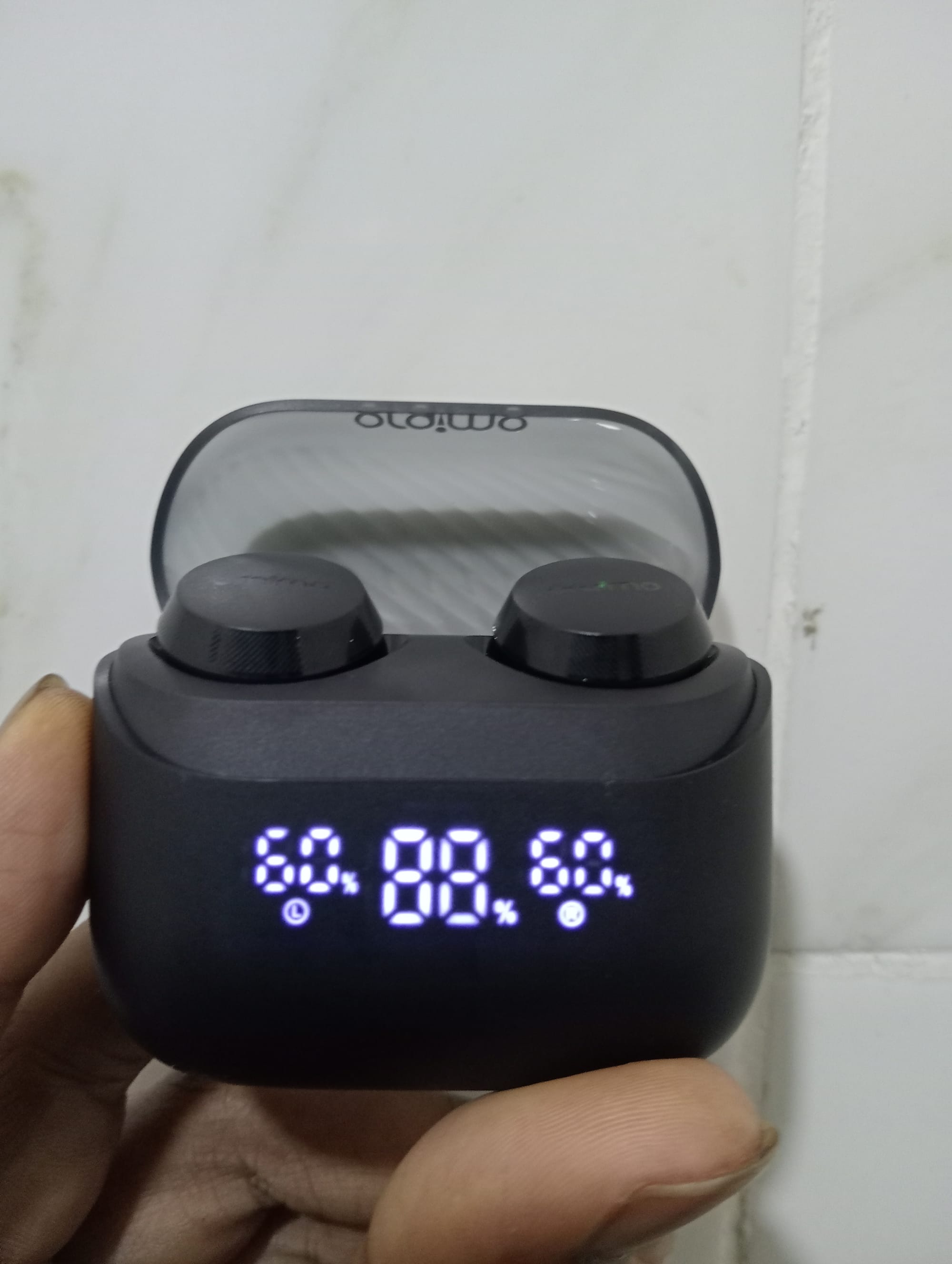 An image of the Oraimo Airbuds 4 ENC with the charging case open and showing battery level | Oraimo Airbuds 4 ENC True Wireless Earbuds Features | Mania Gadgets