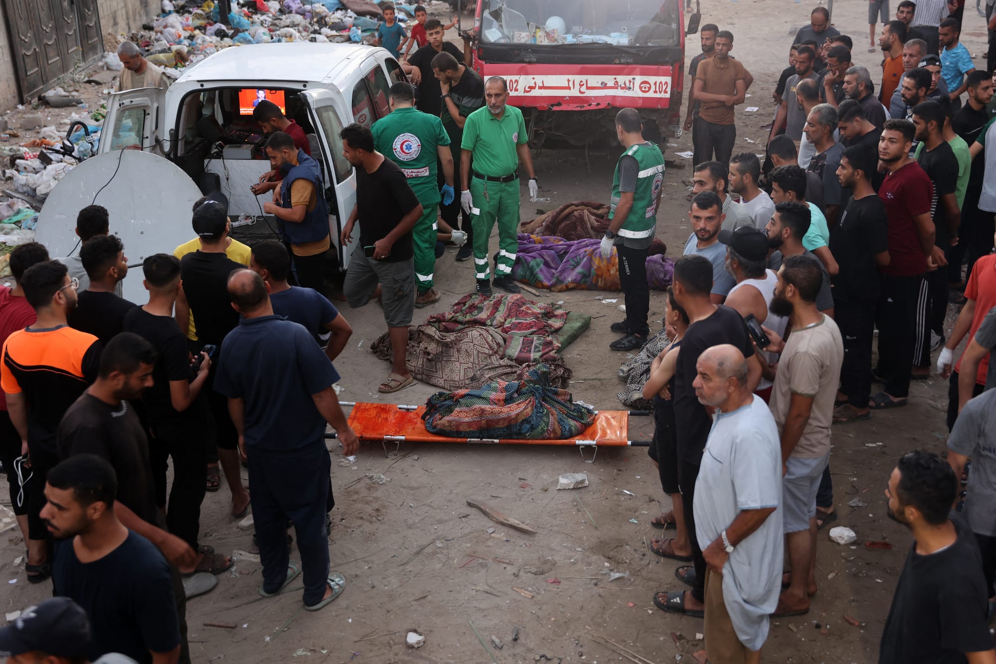 Rescue workers at Al-Tabi’in School | Israeli Attack on Gaza School Claims Over 100 Lives | Mania News