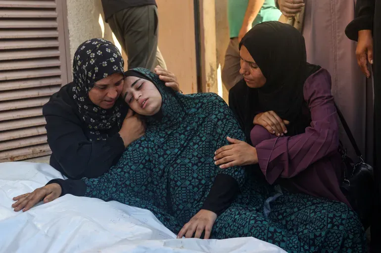 A Palestinian woman mourning the loss of her loved one in the Israeli attack on Al-Tabi’in School | An International Call for Action After Over 100 Dead in Al-Tabi’in School Attack | Mania News