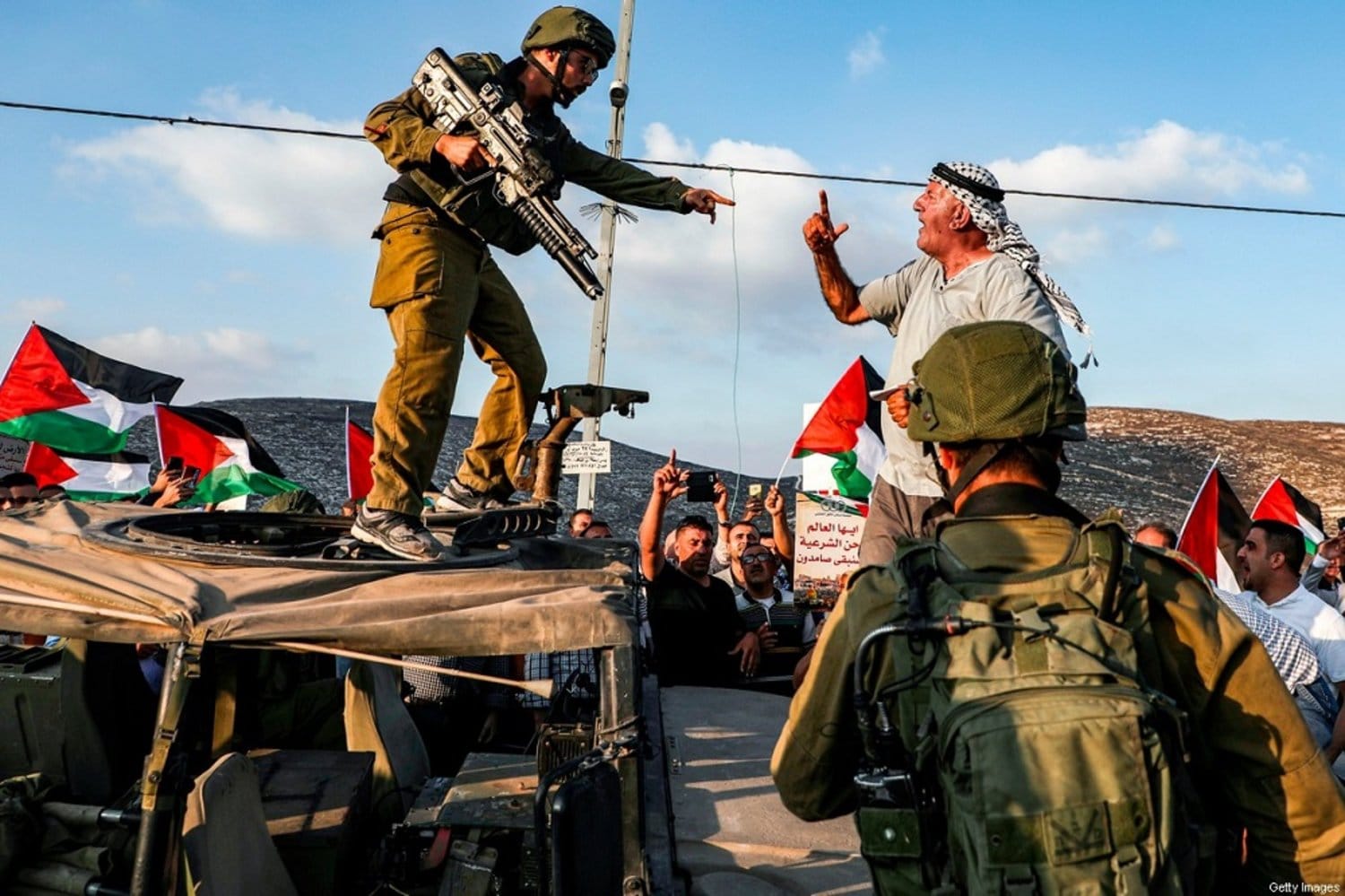 A Palestinian man confronting Israeli soldiers during a Palestinian protest | Key Issues Likely to be Discussed in the Israel-Hamas Ceasefire Negotiations | Mania Politics