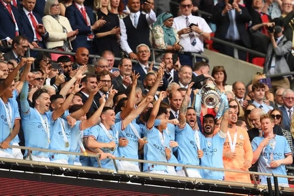 Manchester City's players lifting the FA Cup Trophy